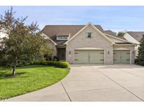 Charming home with a three-car garage, well-manicured lawn, and appealing landscaping at 4139 Bayberry Ct, Greenwood, IN 46143