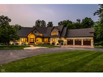 Stunning brick and stone home featuring a circular driveway and three car garage at 4242 Watson Rd, Greenwood, IN 46143