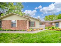 Charming single story home with well maintained lawn, garden and brick facade at 4316 London Ct, Anderson, IN 46013