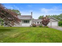 Charming home featuring a spacious yard, attached garage, and well-maintained landscaping at 5330 W 56Th St, Indianapolis, IN 46254