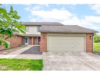 Charming townhouse with a brick facade and attached two-car garage, plus well-maintained landscaping at 5372 Bay Harbor Dr, Indianapolis, IN 46254