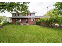 Charming two-story home with a well-manicured lawn and mature trees at 5388 W Hazelrigg Rd, Thorntown, IN 46071