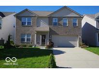 Charming two-story home with a well-maintained lawn, brick facade, attached two-car garage, and welcoming entryway at 6604 Heritage Hill Dr, Indianapolis, IN 46237
