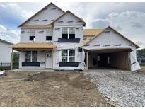Exterior construction of a two-story home with a two car garage and bright natural light at 7242 Barrett Dr, Brownsburg, IN 46112