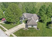 Stunning aerial view of a brick home featuring lush landscaping and a spacious driveway at 7421 Meadow Violet Ct, Avon, IN 46123