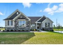 Charming home featuring stone and brick accents, lush green lawn and landscaping, plus a pond at 963 Apryl Dr, Greenwood, IN 46143