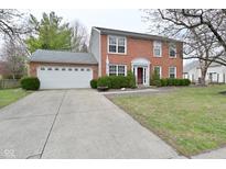 Two-story brick home featuring an attached two-car garage and a well-manicured front yard at 10764 Northhampton Dr, Fishers, IN 46038