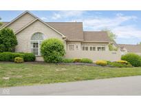Charming brick home featuring a well-maintained yard and inviting curb appeal at 11438 Winding Wood Dr, Indianapolis, IN 46235