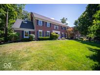 Two-story brick home with dark shutters and a large front lawn at 11536 Woods Bay Ln, Indianapolis, IN 46236