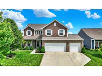 Beautiful two-story home featuring a brick facade, lush green lawn, and an attached two-car garage at 1286 Brookdale Ct, Franklin, IN 46131
