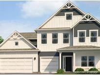 Charming new construction two-story home features white siding, a black front door and a two-car garage at 1534 Trichel Dr, Greenwood, IN 46143
