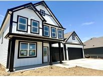 Two-story home featuring a black-and-white exterior, black trim, and an attached two-car garage at 1534 Trichel Dr, Greenwood, IN 46143
