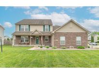 Charming two-story home boasts a well-manicured lawn, a cozy front porch, and classic curb appeal at 1603 Quinn Creek Dr, Brownsburg, IN 46112
