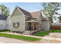 Charming two-story home with a well-manicured lawn and inviting front porch at 1609 S G St, Elwood, IN 46036
