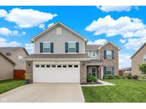 Charming two-story home with a combination of siding and brick, enhanced by dark shutters and a well-manicured lawn at 18258 Rickety Dr, Westfield, IN 46074