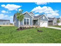 Charming single-Gathering home with blue siding, stone accents, manicured lawn, and inviting curb appeal at 19762 Highclere Lane, Sheridan, IN 46069