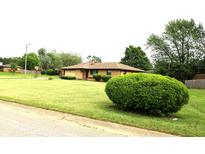Charming brick ranch home featuring a lush lawn and mature landscaping at 2315 Redfern Dr, Indianapolis, IN 46227