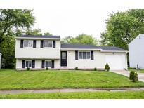 Charming split-level home with a well-manicured lawn and attached one car garage at 2740 Pawnee Dr, Indianapolis, IN 46229