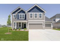Beautiful two-story home with a three car garage, blue accents and well manicured lawn at 3226 Promenade Way, Brownsburg, IN 46112