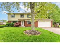 Charming two-story home with a brick facade, well-maintained lawn, and attached two-car garage at 3325 Broadview Ct, Indianapolis, IN 46227
