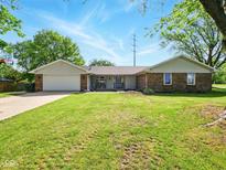 Charming single-story brick home with an attached garage and a well-manicured front lawn at 5200 N Leslie Dr, Muncie, IN 47304