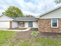 Charming single-story home featuring a welcoming entrance, well-maintained lawn, and a blend of brick and siding exterior at 5200 N Leslie Dr, Muncie, IN 47304