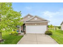 Charming single-story home featuring a brick facade, well-maintained lawn, and a two-car garage at 5410 Brassie Dr, Indianapolis, IN 46235