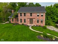 Charming two-story brick home featuring a well-maintained yard with a cozy walkway to the front entrance at 6567 Kings Ct, Avon, IN 46123