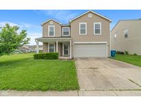 Charming two-story home with a well-maintained lawn and attached two-car garage at 8238 Crackling Ln, Indianapolis, IN 46259
