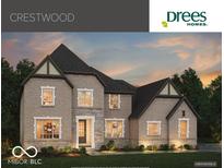 Stunning two-story brick home with stone accents, gabled roof, and manicured landscaping at 9602 Fall Creek Rd, Indianapolis, IN 46256
