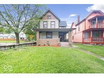 Charming two-story home with brick accents and a welcoming front porch at 989 Woodruff Pl E Dr, Indianapolis, IN 46201
