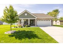 Charming single-story home with a well-manicured lawn and a two-car garage at 1021 Boots Trl, Greenfield, IN 46140