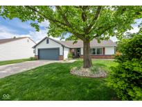 Charming single-story home featuring a lush front yard and attached garage at 1084 Lake W Dr, Brownsburg, IN 46112