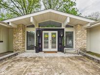 Inviting front entrance with stone accents, double doors, and decorative wreaths provides great curb appeal at 12 Windridge St, Country Club Heights, IN 46011