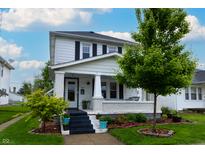 Charming two-story home with a covered front porch and beautifully landscaped yard at 1207 Chestnut St, Columbus, IN 47201