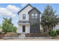 Modern two-story home with black and white exterior, landscaped yard, and covered front porch at 1231 Marlowe Ave, Indianapolis, IN 46202