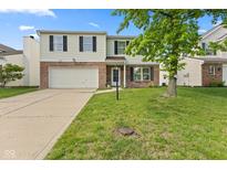 Traditional two-story home with a large front yard, attached garage, and charming curb appeal on a sunny day at 12422 River Valley Dr, Fishers, IN 46037