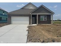 Charming single-story brick home featuring a pristine white garage door and manicured lawn on a sunny day at 1266 Foxtail Ln, Greenwood, IN 46143