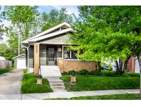 Charming home exterior with a well-manicured lawn and welcoming front porch at 1426 N Euclid Ave, Indianapolis, IN 46201