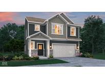 Charming two-story home with a mix of gray siding, stone accents, and well-manicured landscaping at 15338 Farrington Way, Fishers, IN 46037