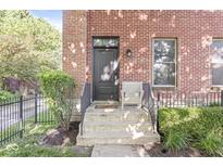 Charming brick home featuring a welcoming front door and manicured landscaping at 1540 N College Ave, Indianapolis, IN 46202