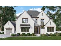 Charming two-story home with white brick, black window frames, and beautiful landscaping at 1713 Deer Creek Way, Columbus, IN 47201