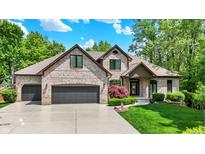 Charming two-story brick home with well-manicured lawn and attached two-car garage at 1860 Red Fox E Ct, Martinsville, IN 46151