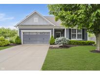 Charming home featuring a gray two-car garage, blue siding, and a lush green lawn at 18630 Goldwater Rd, Westfield, IN 46062