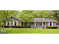 Charming single-story home with brick accents, large windows, and a well-manicured lawn with mature trees at 19446 Ethan Allen Ln, Westfield, IN 46074