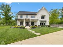 Charming two-story home with black accents, manicured lawn, and inviting front porch seating at 20400 Chatham Hills Blvd, Westfield, IN 46074
