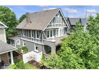 Stunning exterior of a well-kept two-story home with lush greenery and a classic chimney design at 2134 N Alabama St, Indianapolis, IN 46202