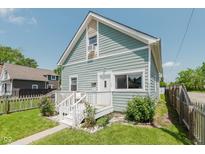 Charming two-story home with light blue siding, white trim, and a cozy front porch at 2230 Pleasant St, Indianapolis, IN 46203