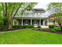 Charming two-story home featuring a welcoming front porch and a well-maintained front yard at 4130 N Meridian St, Indianapolis, IN 46208
