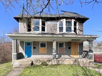 Two story home needing renovation with blue door and covered porch at 430 N Hamilton Ave # 430, Indianapolis, IN 46201